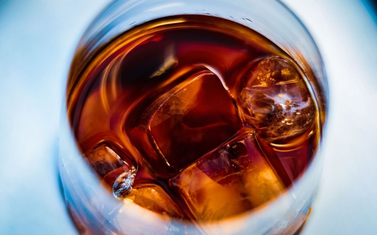 Whiskey in a glass over large ice cubes