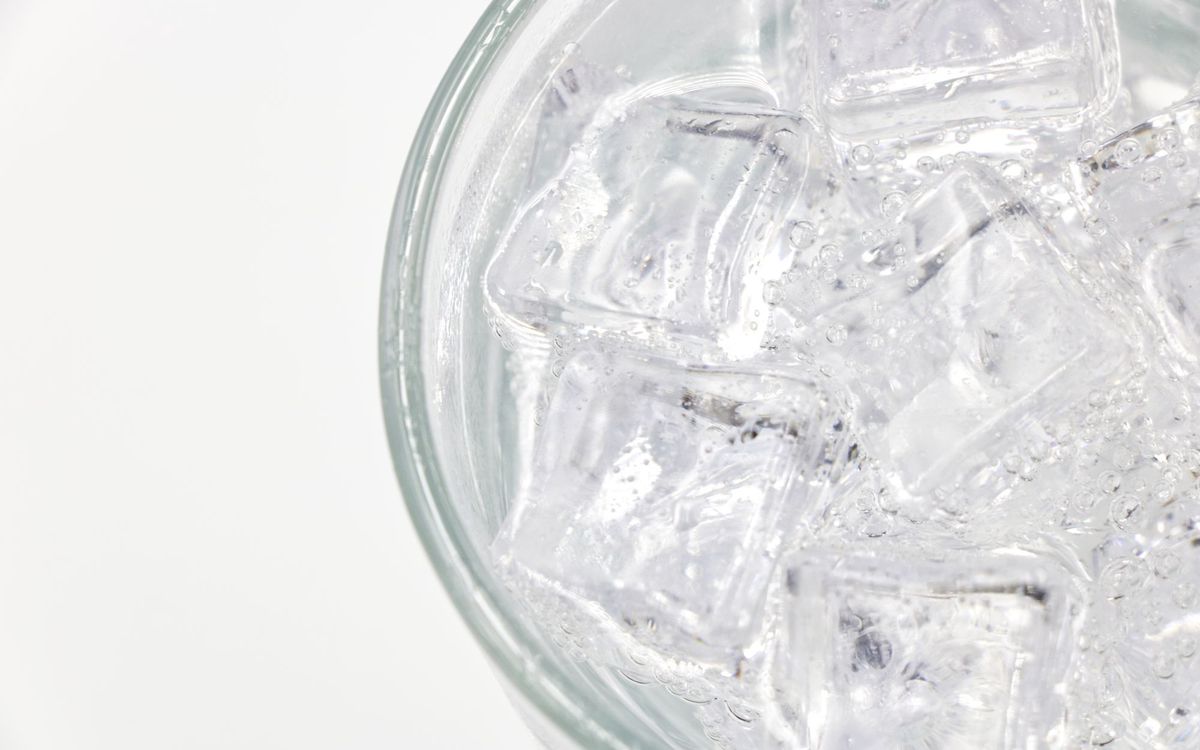Ice cubes in a glass of sparkling water, the starting point before crushing into nugget ice