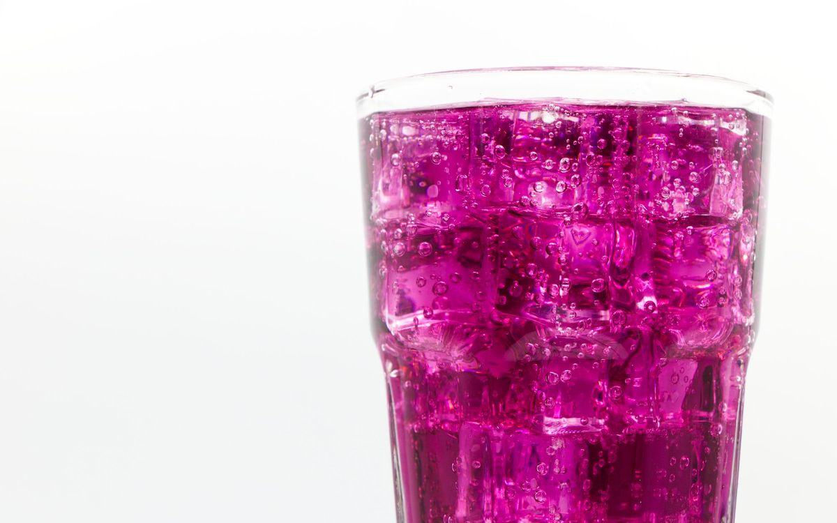Tall glass of a purple soda drink filled with ice, a good fit for soft crushed or nugget ice