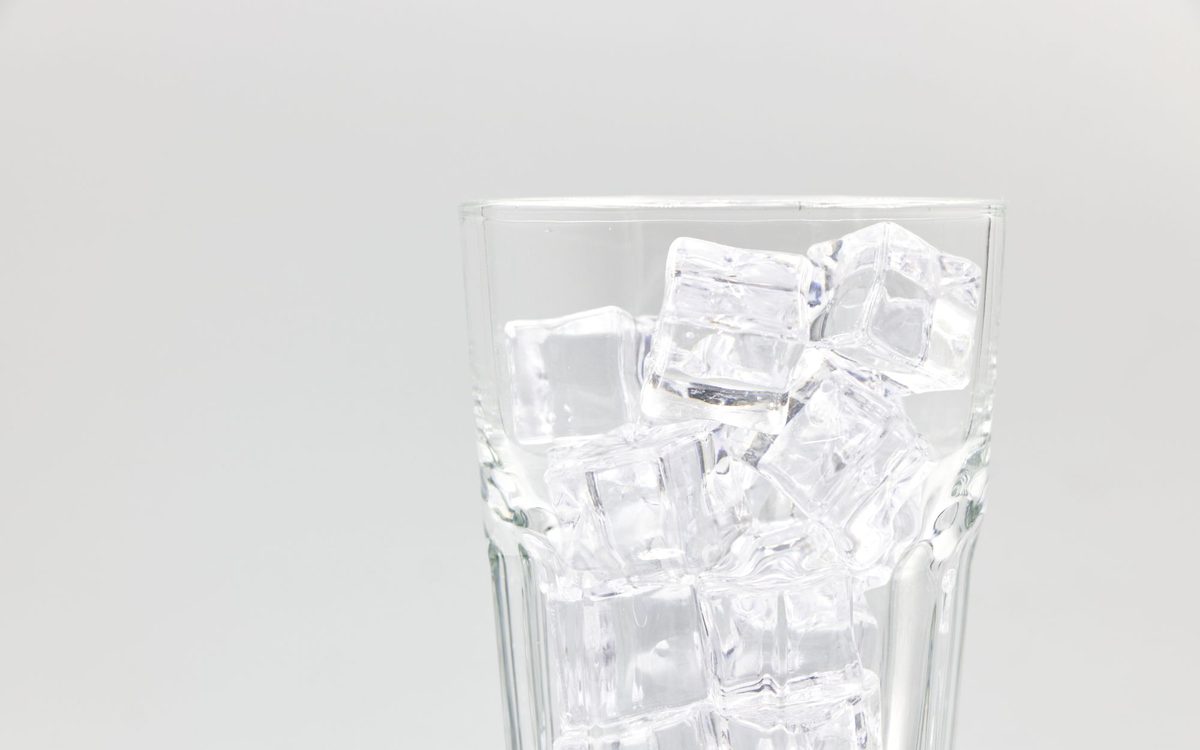 Glass filled with ice cubes ready to be crushed into nugget ice at home